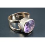 A 1970s amethyst finger ring, comprising a round brilliant cut amethyst 10 mm diameter, in a