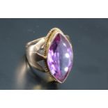 An Egyptian purple sapphire ring, comprising a large marquise cut stone of approx 25 mm x 10 mm / 14