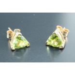 A pair of green trillion shaped earrings, in three point gallery settings, marked "375", 1.45 g,