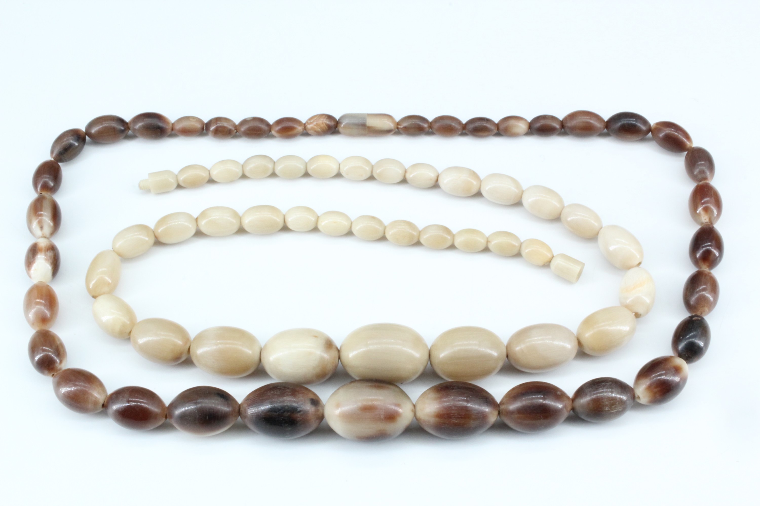 Two horn bead necklaces, 61 cm, largest bead 28 mm x 20 mm, and 57 cm, 28 mm x 20 mm