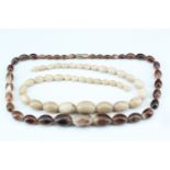 Two horn bead necklaces, 61 cm, largest bead 28 mm x 20 mm, and 57 cm, 28 mm x 20 mm