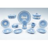 A quantity of Wedgwood blue Jasperware including a vase, three lidded boxes, six pin dishes, a plate