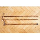 Two antler topped walking sticks, having twisted shafts together with a plain shafted antler