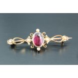 A late 19th / early 20th Century almandine and seed pearl openwork brooch, the oval facet-cut