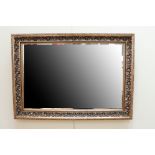 An antiqued-gilt framed oblong wall mirror, 75 cm x 58 cm