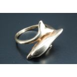 A lady's dolphin finger ring, the shoulders morphing into a dolphin's body and tail respectively, as