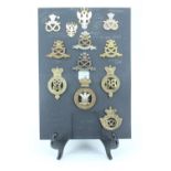 A group of 64th / 98th of Foot, Staffordshire Regiment and related cap badges