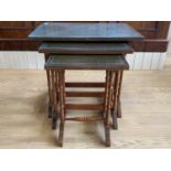 A nest of glass and tooled leather topped mahogany tables, 59 cm x 41 cm x 53 cm
