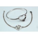 two silver bracelets, comprising a chain bracelet with a central roundel embellished with a thistle,