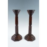 A pair of early 20th Century Arts and Crafts inspired brass-inlaid wooden candlesticks, 36 cm