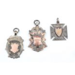 Three late 19th / early 20th Century silver and parcel gilt watch fobs, all with vacant