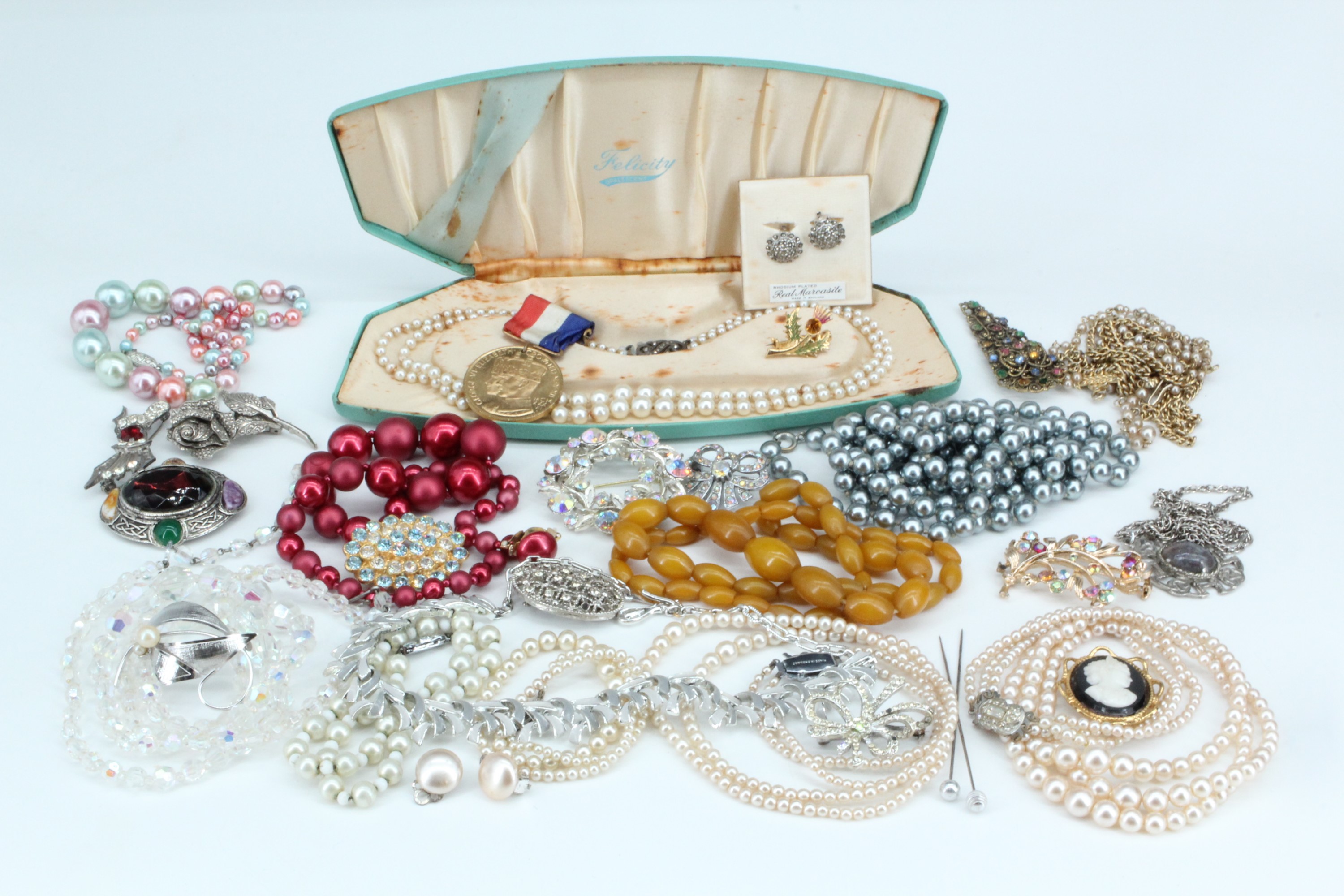 A large quantity of vintage costume jewellery and a Gothic chip carved wooden casket