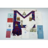 A Masonic apron and gloves, rule books, function invitations, etc. together with a silver gilt