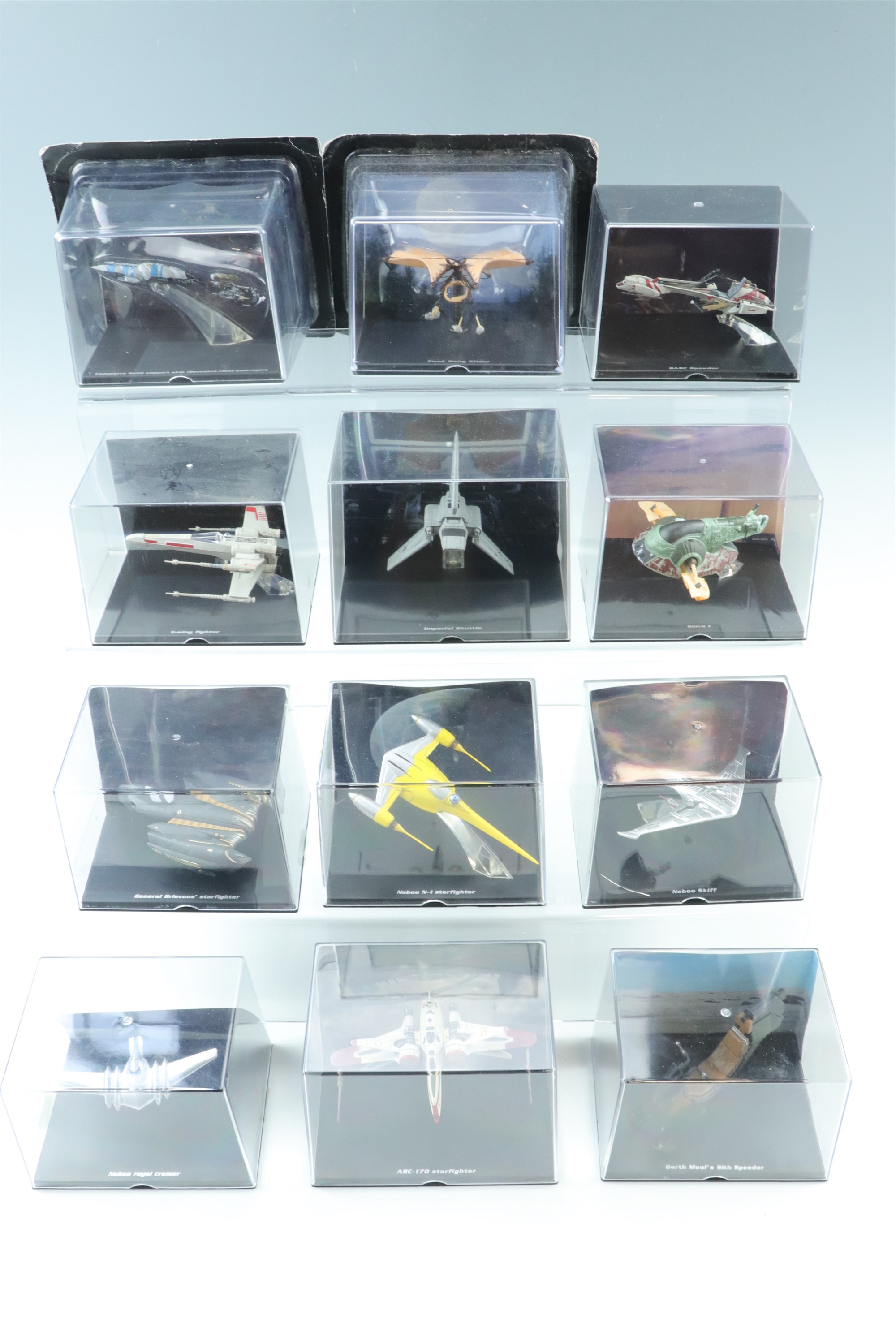 A large quantity of De Agostini Star Wars collectors models in display cases including "Millennium