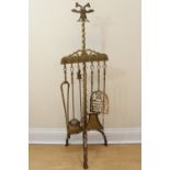 An uncommonly large brass fireside hearth implement set, its stand having a double headed eagle