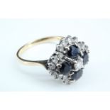 A sapphire and diamond cluster ring, having a central round diamond of approximately 3 mm