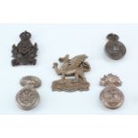 Five Second World War plastic cap badges