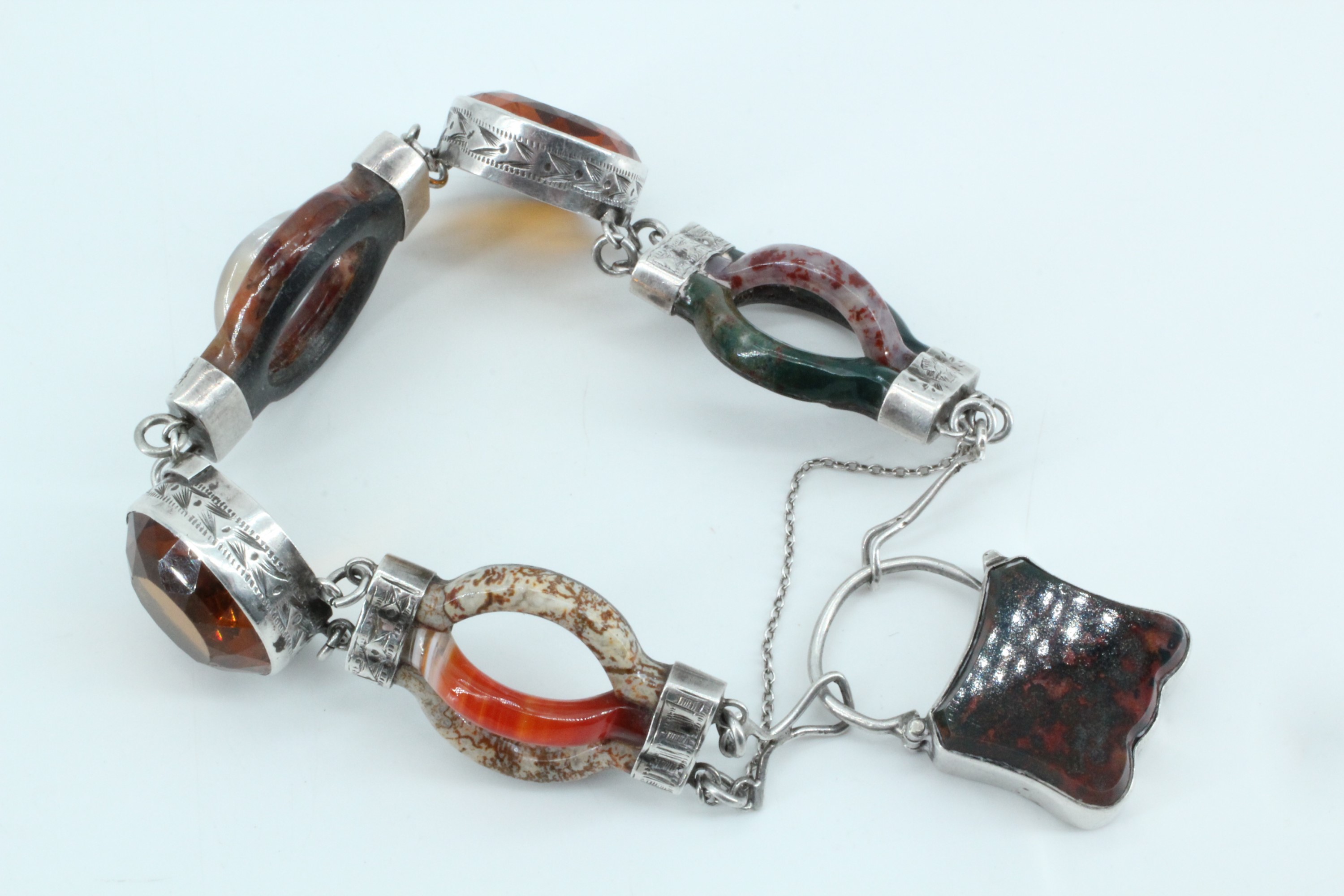 A fine Victorian Scottish polished hard stone and white metal bracelet of triple-arc open links,