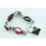 A fine Victorian Scottish polished hard stone and white metal bracelet of triple-arc open links,