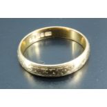 A 22 carat gold wedding band, having rubbed bright cut engraved decoration, Birmingham, 1956, 3.46