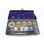 A vintage Bakelite cased set of brass gram weights, 15 cm x 7 cm x 3.5 cm