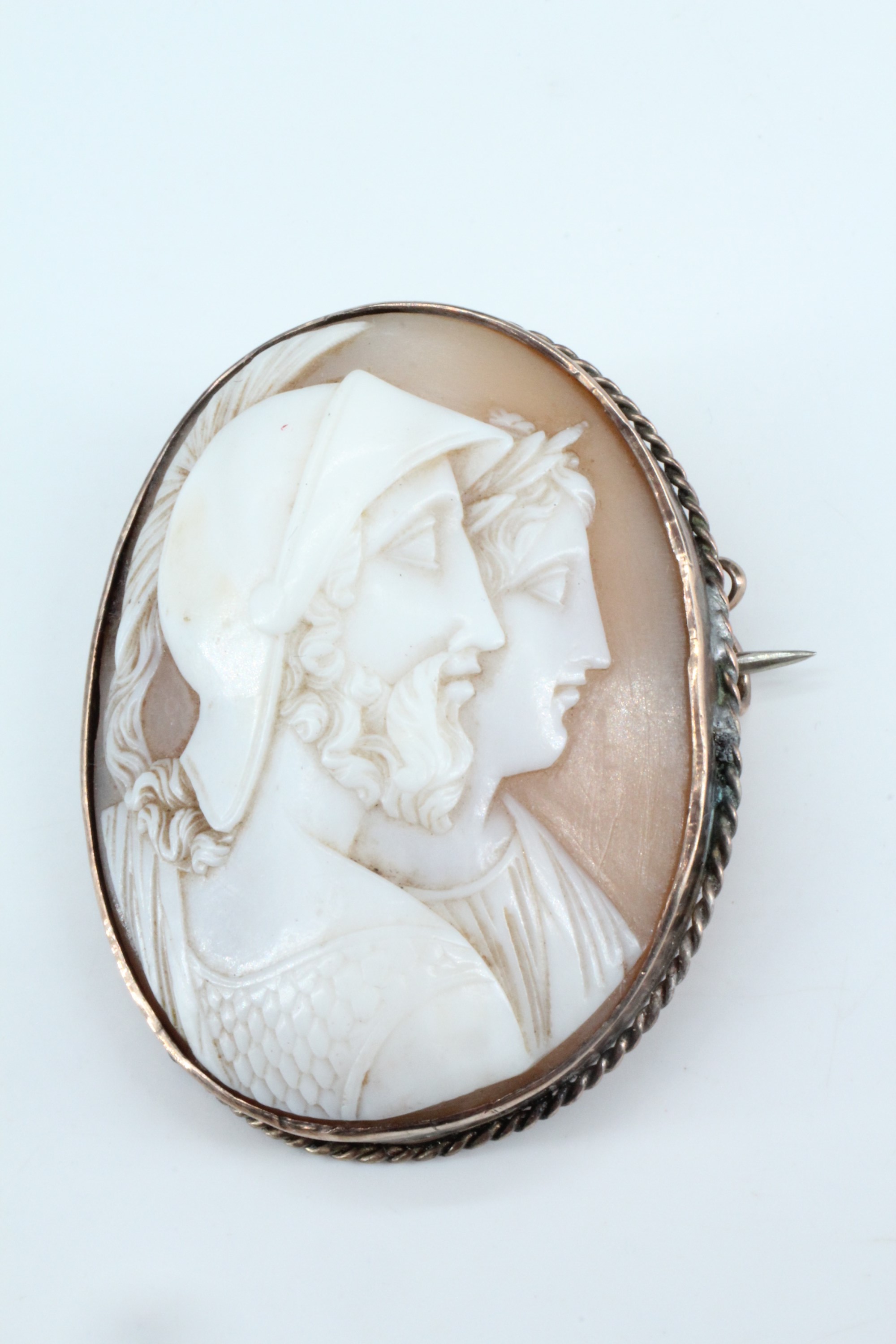 A late 19th / early 20th Century shell cameo brooch, the oval cameo depicting in profile a classical