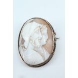 A late 19th / early 20th Century shell cameo brooch, the oval cameo depicting in profile a classical