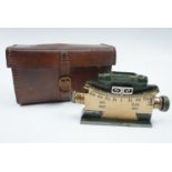 A military clinometer in leather case, the latter stamped "Case Mk II, Clinometer, Vickers .303 M