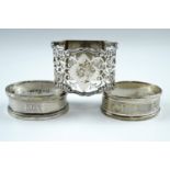 An Edwardian pierced silver napkin ring, having a vacant lozenge to the top and a flat base,