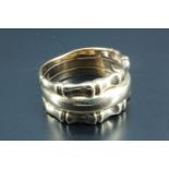 A lady's 9 carat gold tripartite ring, being a concave tapering central band between two bamboo
