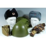 A quantity of Soviet Bloc military clothing and kit including a helmet, camouflage oversuit, belt