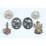 A small group of South African military cap badges