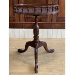 A reproduction Georgian tripod drinks table, having a gallery top and acanthus-carved legs with