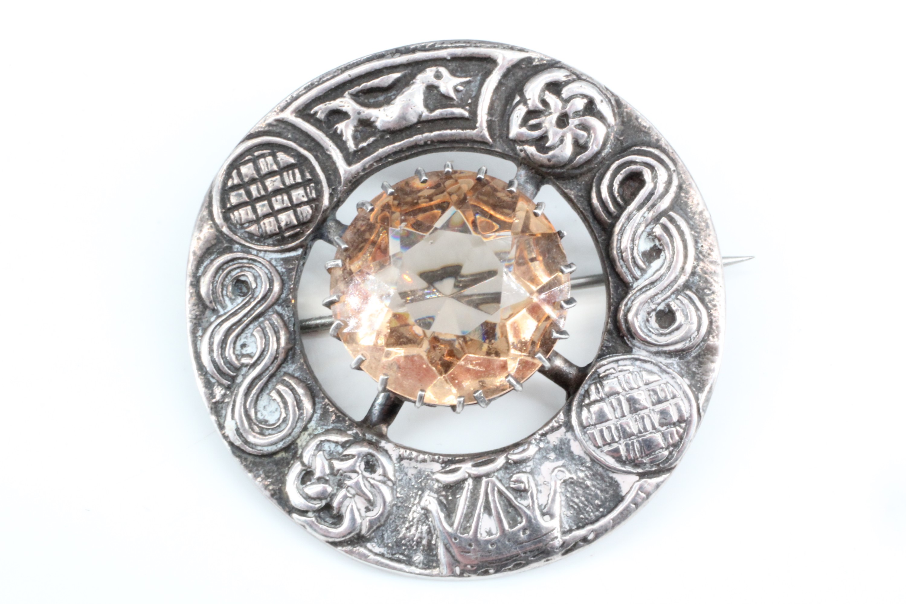 A Scottish Celtic influenced silver plaid brooch, comprising an annulus relief-decorated with Celtic