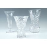 Three cut glass vases, tallest 25 cm