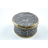 A late 19th Century brass-mounted embossed tinplate drum-form pill or trinket box, 4.5 cm x 2.5 cm