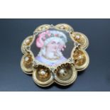 A Victorian enamelled and yellow metal brooch, having a hand painted enamel portrait miniature of