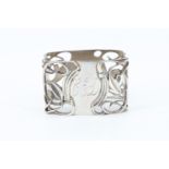 An Art Nouveau influenced Scottish silver napkin ring, having pierced sinuous decoration, Michael
