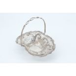 A Rococo influenced small swing handled bon-bon basket, of oval form with reticulated sides and