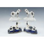A pair of early 20th Century Staffordshire pottery spaniel spill holders, together with a pair of