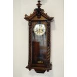 A late 19th / early 20th Century part-ebonised walnut Vienna style wall clock, 81 cm