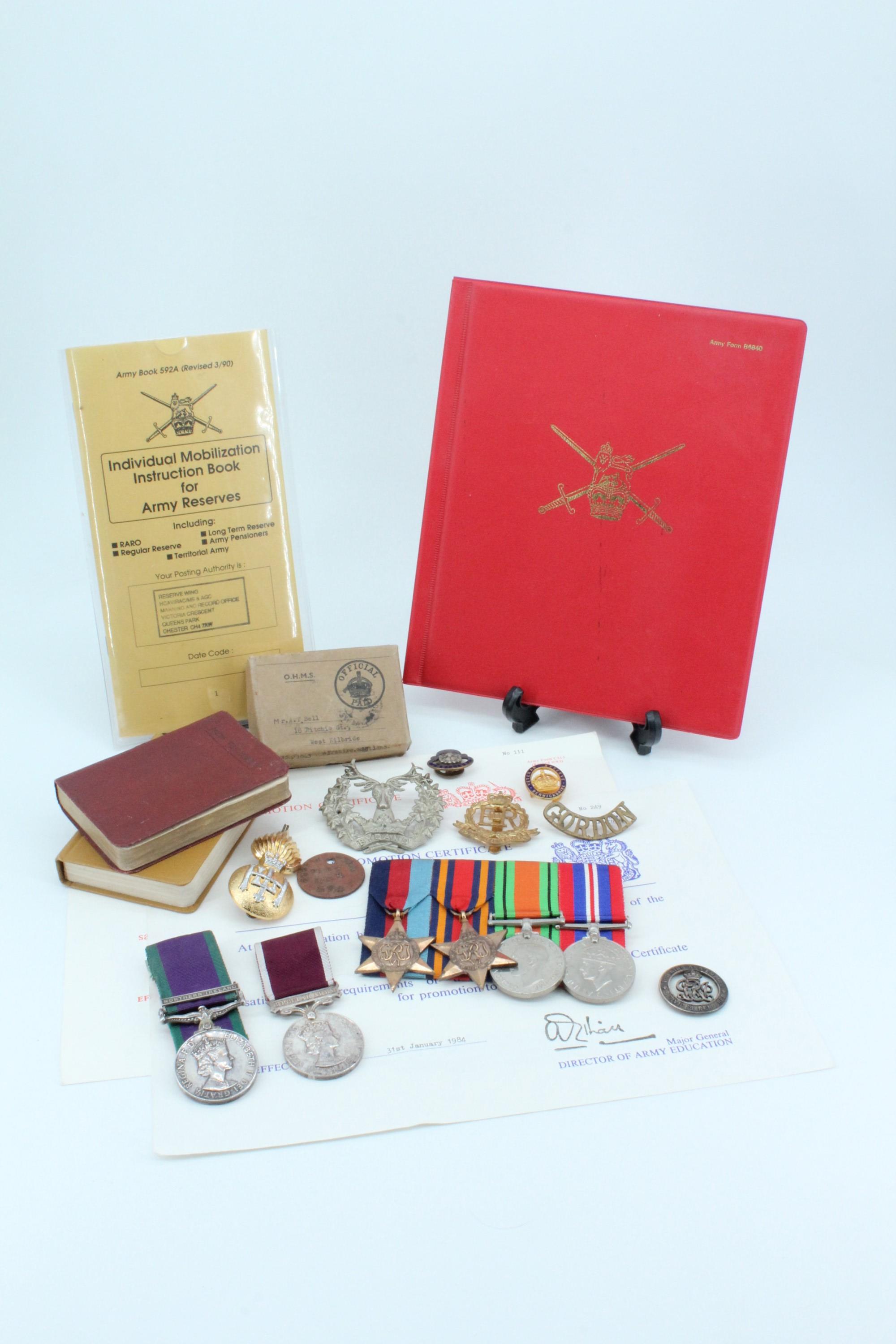 A three-generation British army service group, comprising an identity disc, cap badge and shoulder