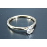 A contemporary diamond solitaire ring, the brilliant cut stone of approximately .1 ct, illusion