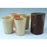 A cased set of four nesting early 20th Century Bandalasta Ware composition travel cups