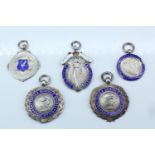 Five early 20th Century silver and enamel sports medals, comprising Civil Service Athletic