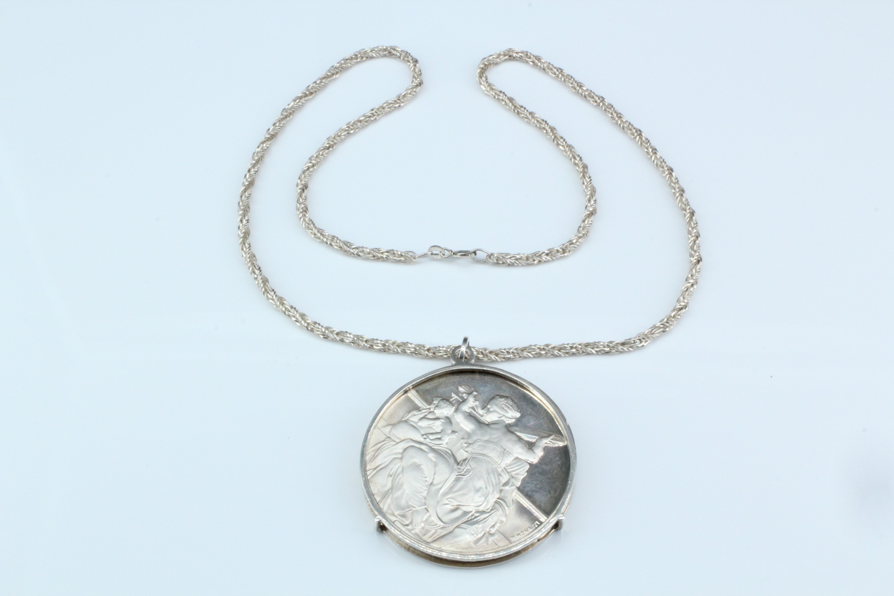 A 1970s Sistine chapel silver medallion necklace, comprising a medallion from the "Genius of