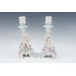 A pair of late 19th Century German porcelain figural candlesticks modeled as men leading horses, (