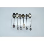 Two 800 marked white metal Maltese cross teaspoons having coin bowls together with four other