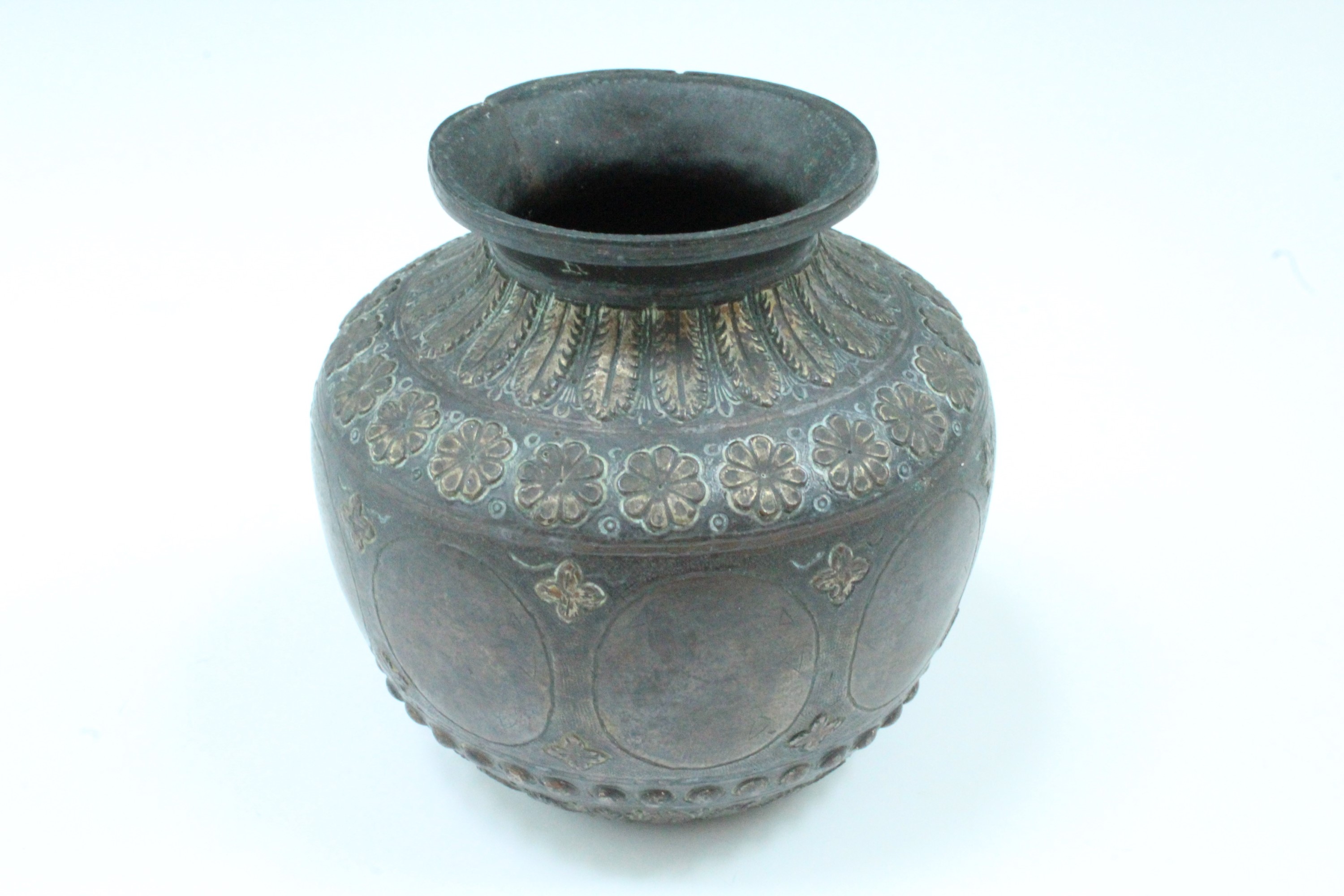 An Ottoman or Middle Eastern chiselled bronze vase, of compressed shouldered form with everted