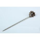 A Victorian stick pin, its terminal in the form of a star and crescent set with a pink stone and